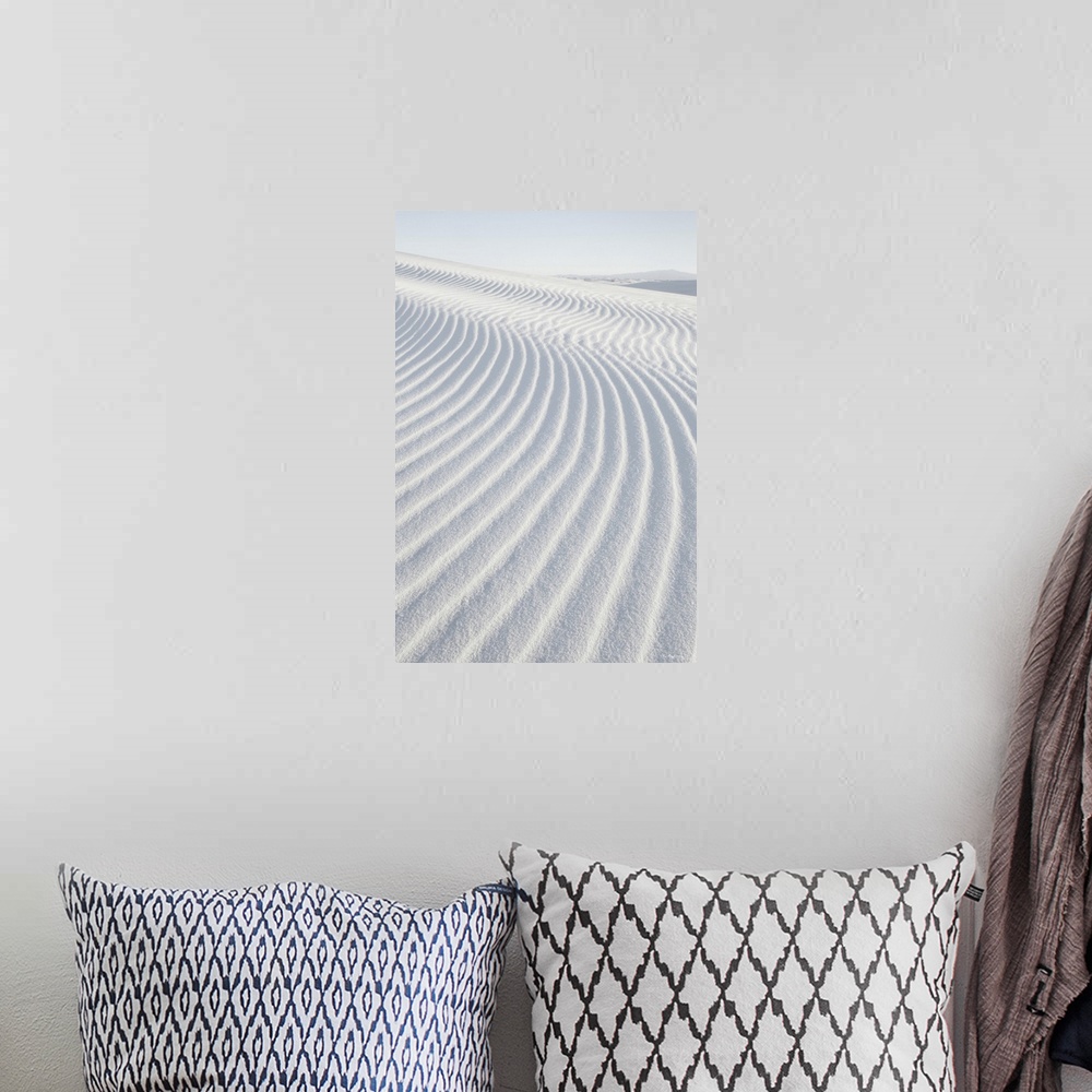 A bohemian room featuring A vertical photograph of ripples in the sand dunes created by the wind.