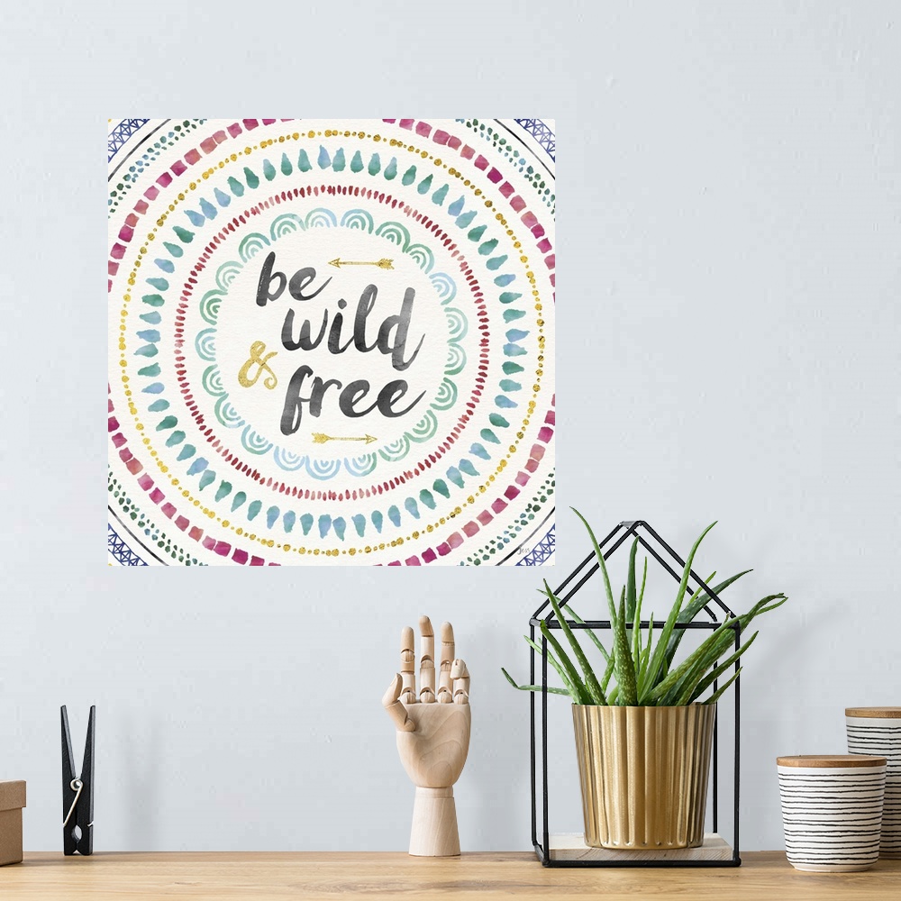 A bohemian room featuring Colorful mandala watercolor painting with the phrase "Be Wild and Free" in the center with two go...