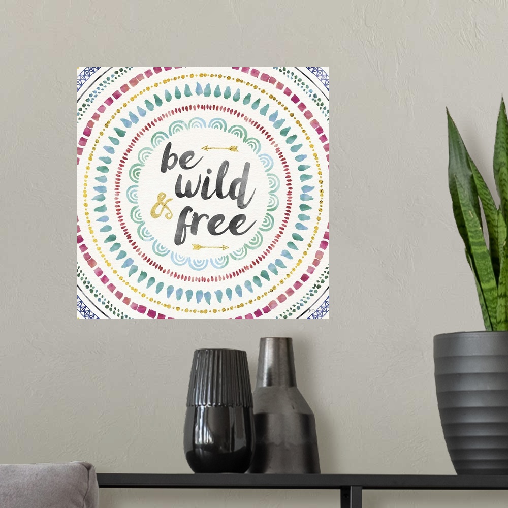 A modern room featuring Colorful mandala watercolor painting with the phrase "Be Wild and Free" in the center with two go...