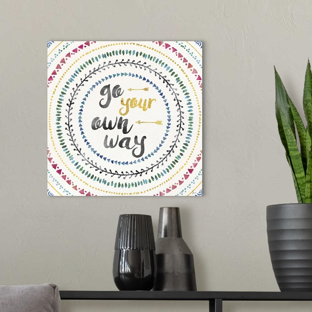 A modern room featuring Colorful mandala watercolor painting with the phrase "Go Your Own Way" in the center with two gol...