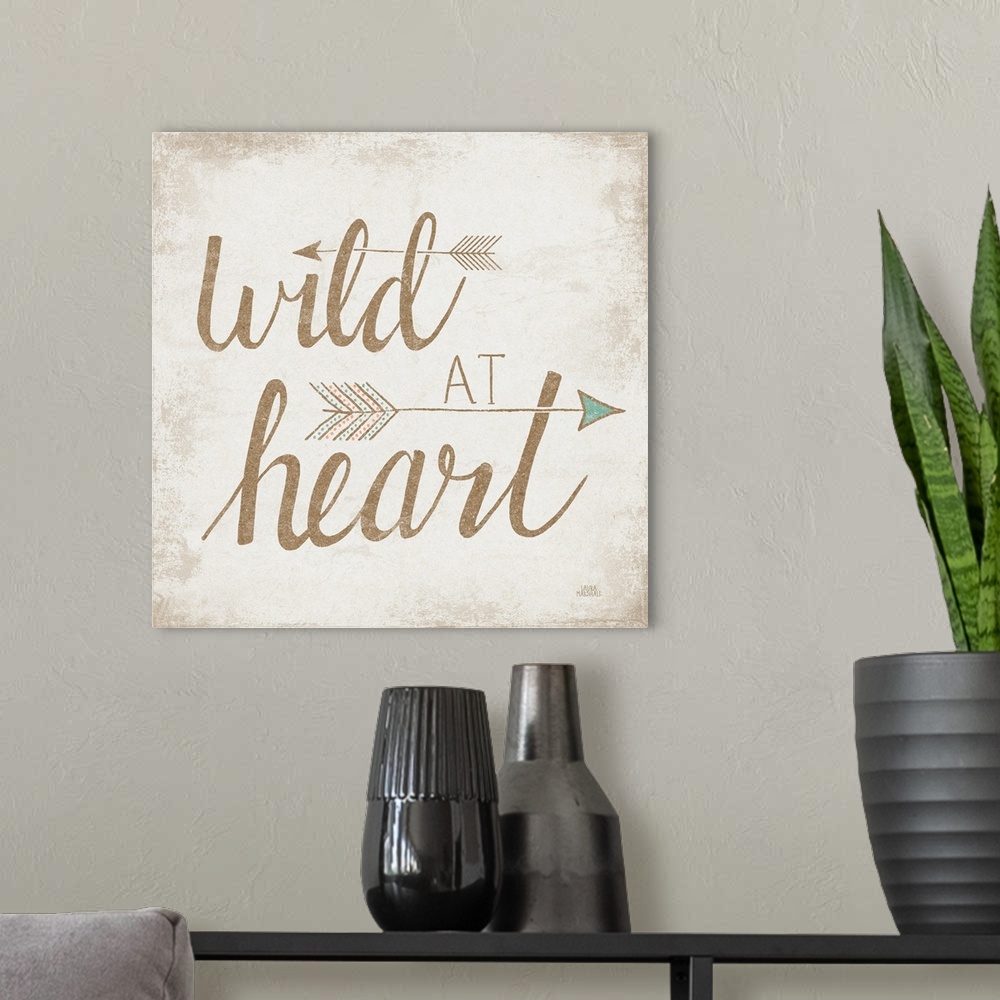 A modern room featuring "Wild At Heart" with two arrows on a beige brushed backdrop.