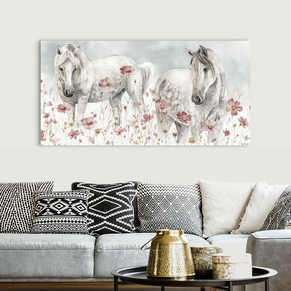 A bohemian room featuring Contemporary watercolor artwork of two white horses in a field of wildflowers.