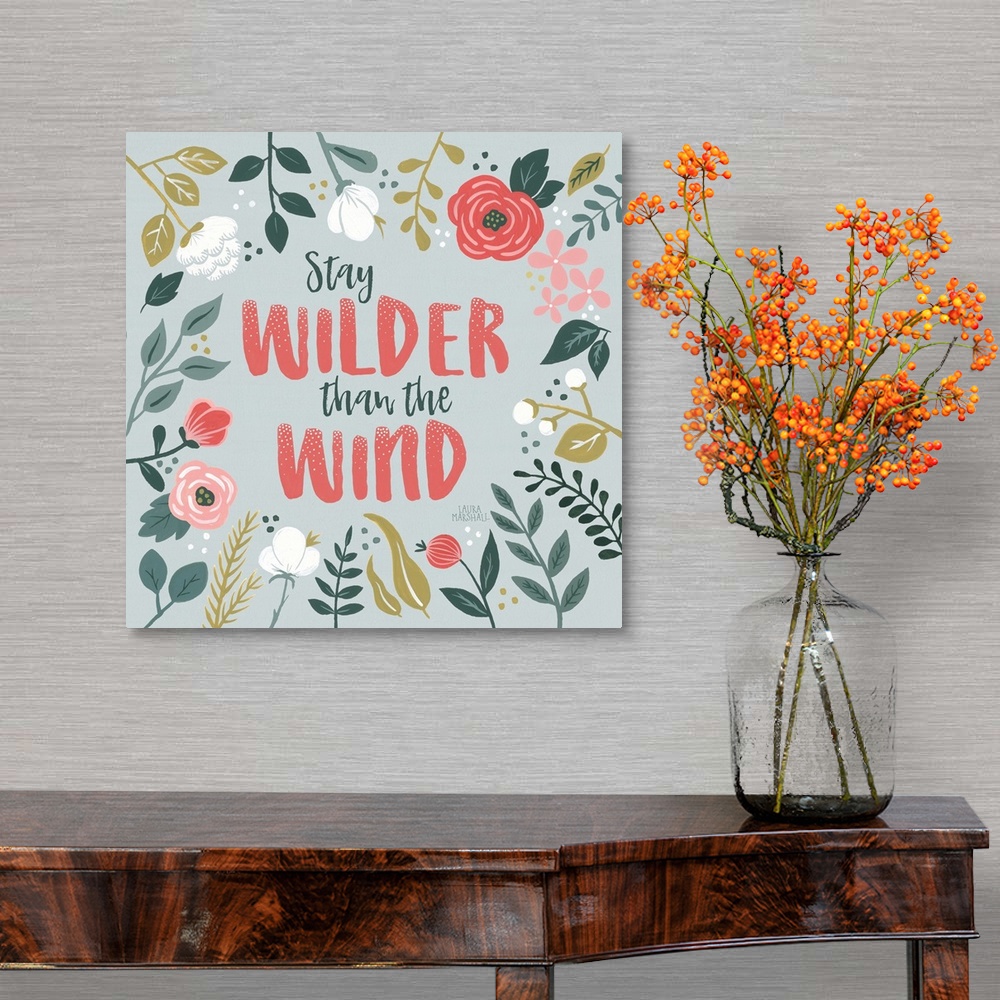 A traditional room featuring "Stay Wilder Than The Wind" framed by wild flowers on a gray background.