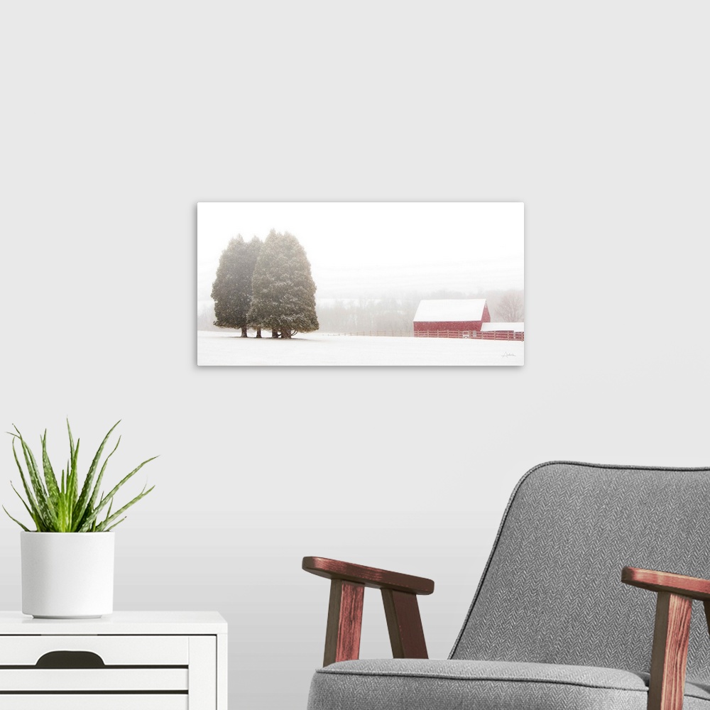 A modern room featuring Image of snow falling on a snow covered red barn in a field.