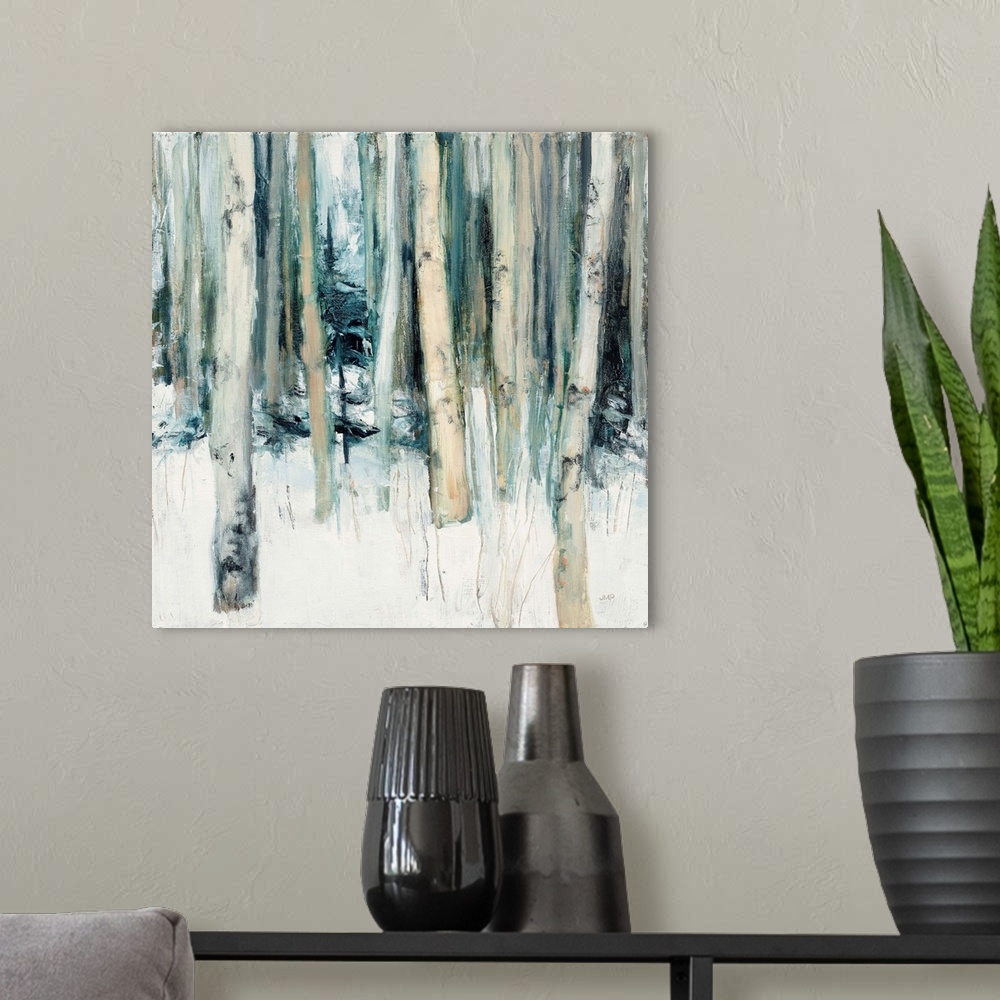 A modern room featuring Square abstract painting of birch trees in the woods covered in snow with cool tones.
