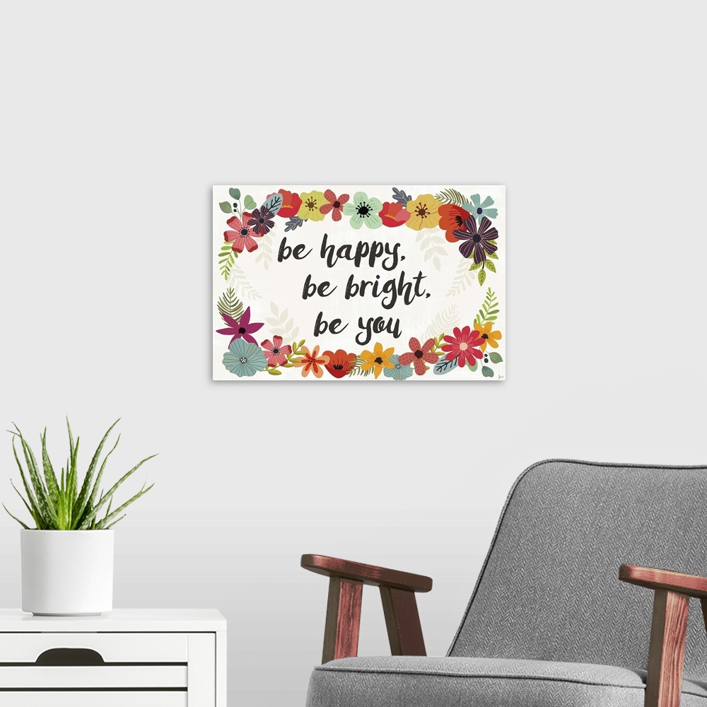 A modern room featuring "Be Happy, Be Bright, Be You" written in the center of a colorful floral wreath.