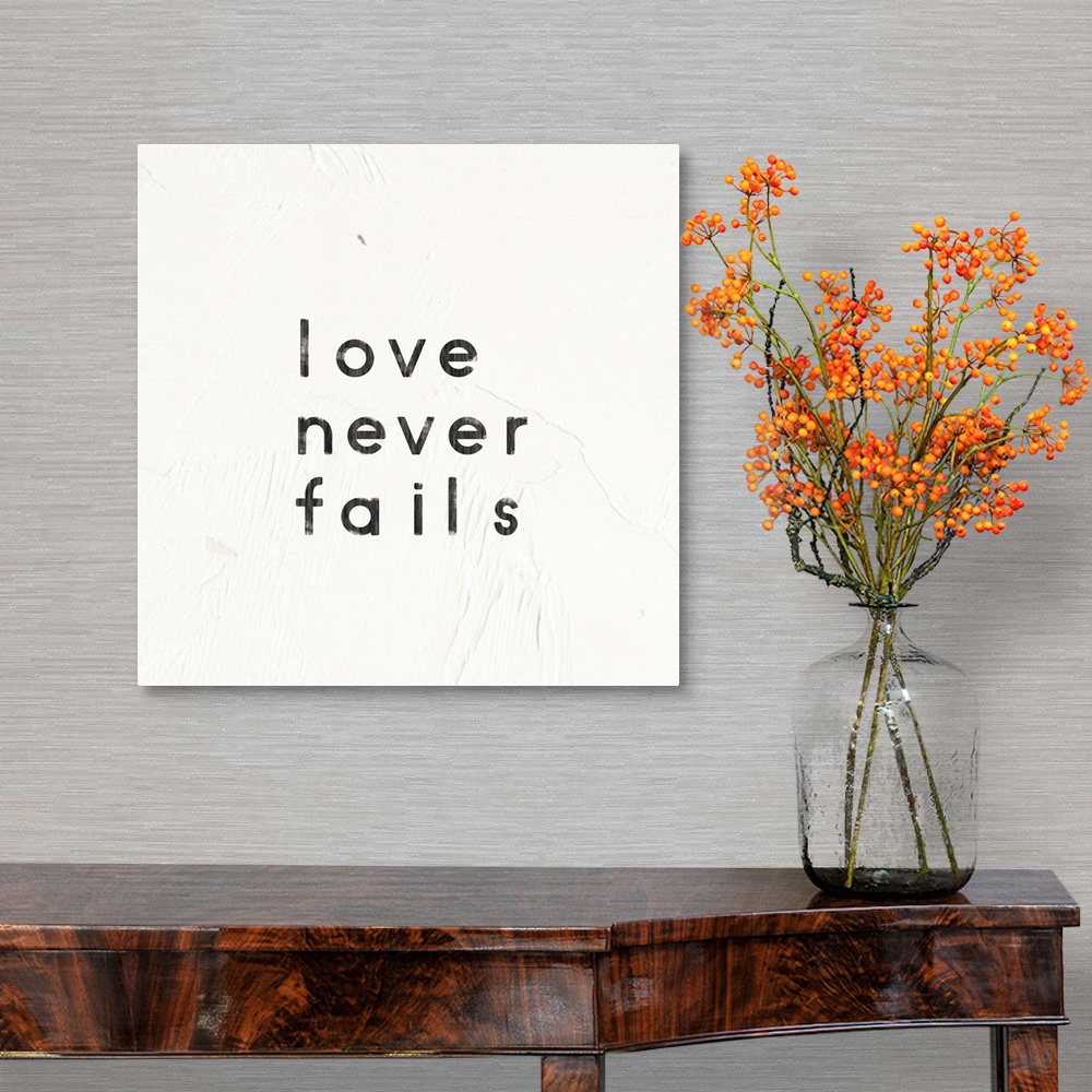 A traditional room featuring "Love Never Fails" written on a painted white texture background.