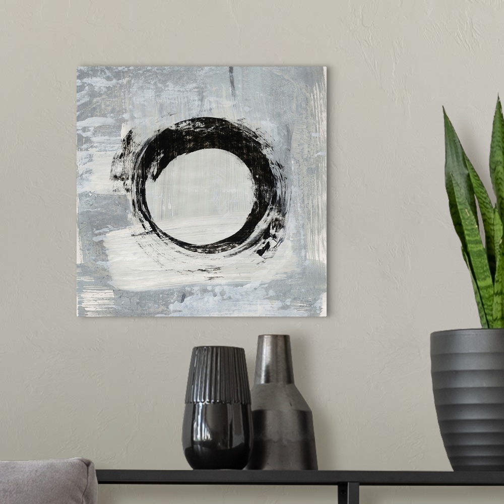 A modern room featuring Square abstract painting of a bold, black circle on a gray and white background.