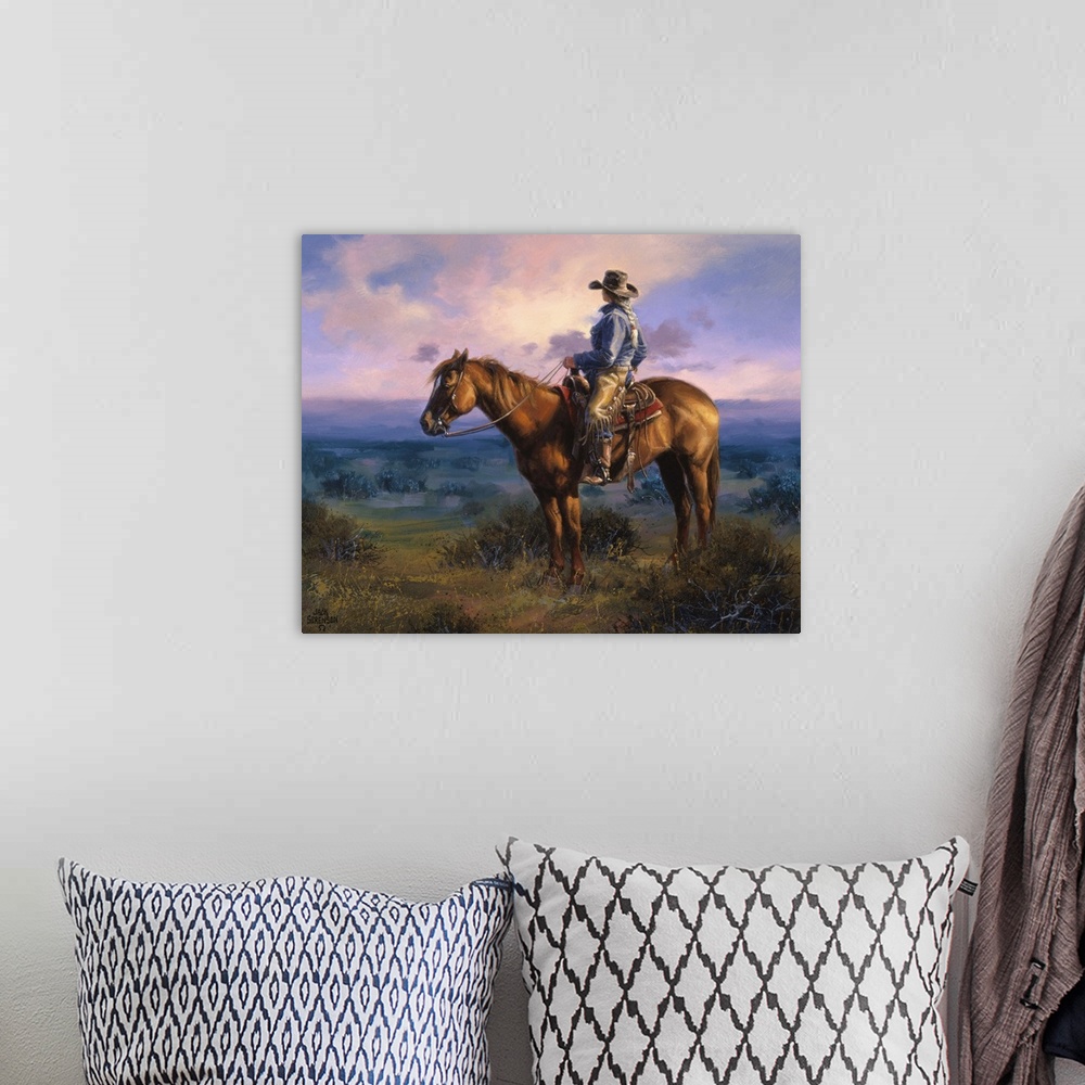 A bohemian room featuring Contemporary Western artwork of a cowboy on his horse in the glow of the setting sun.