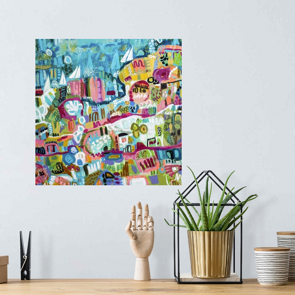 A bohemian room featuring Contemporary artwork of an aerial view of a beachside town and ocean with sailboats in the water.