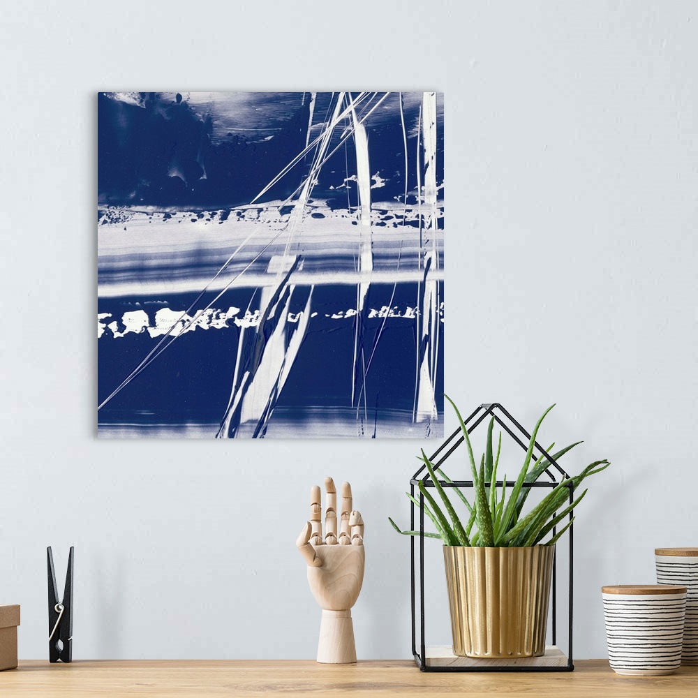 A bohemian room featuring Square abstract painting in blue and white with lines scratched across.