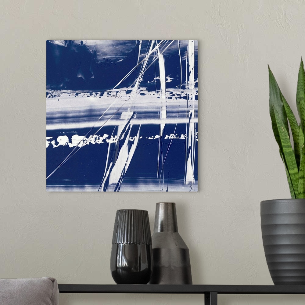 A modern room featuring Square abstract painting in blue and white with lines scratched across.