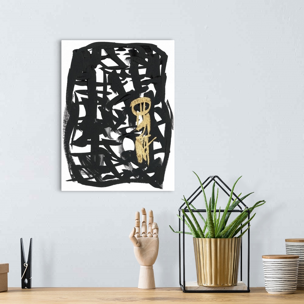 A bohemian room featuring Broad brush strokes in black and gold create letter-like abstract characters surrounded by a bord...