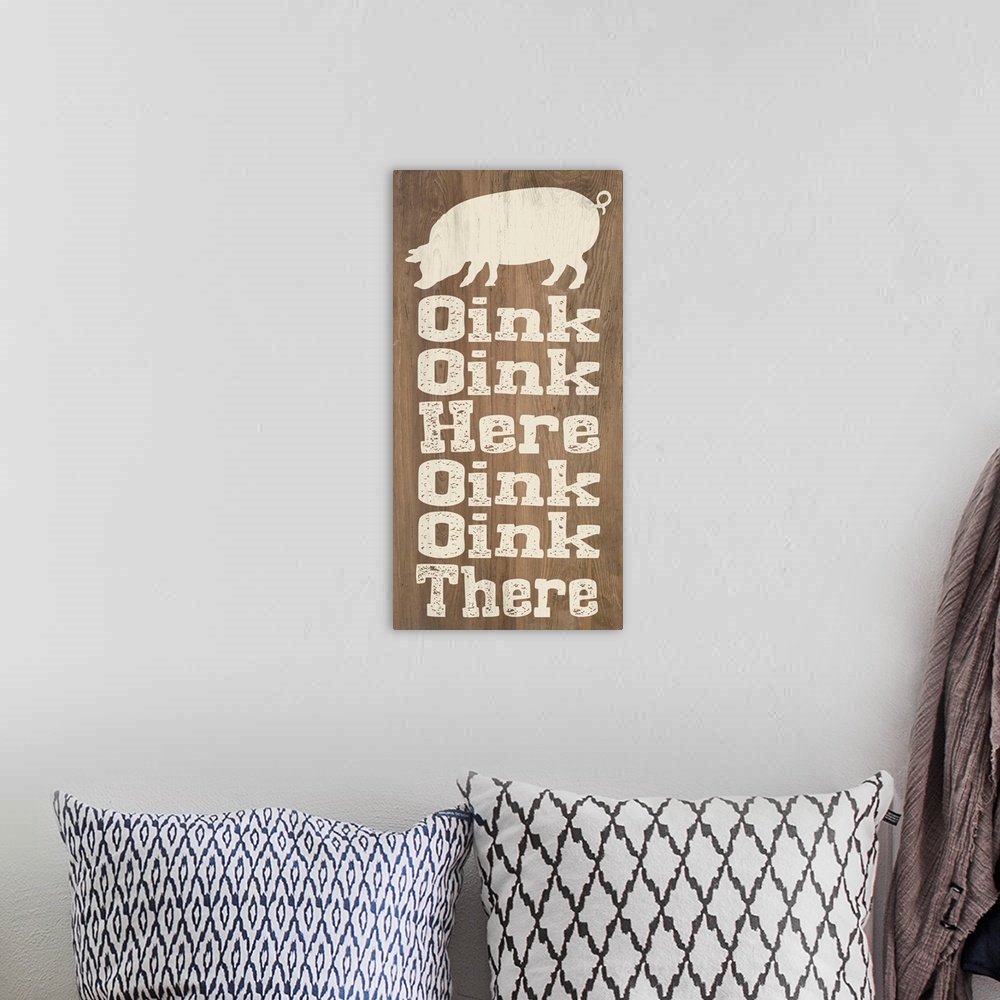 A bohemian room featuring "Oink Oink Here Oink Oink There" written on a wooden background with a pig silhouette at the top.