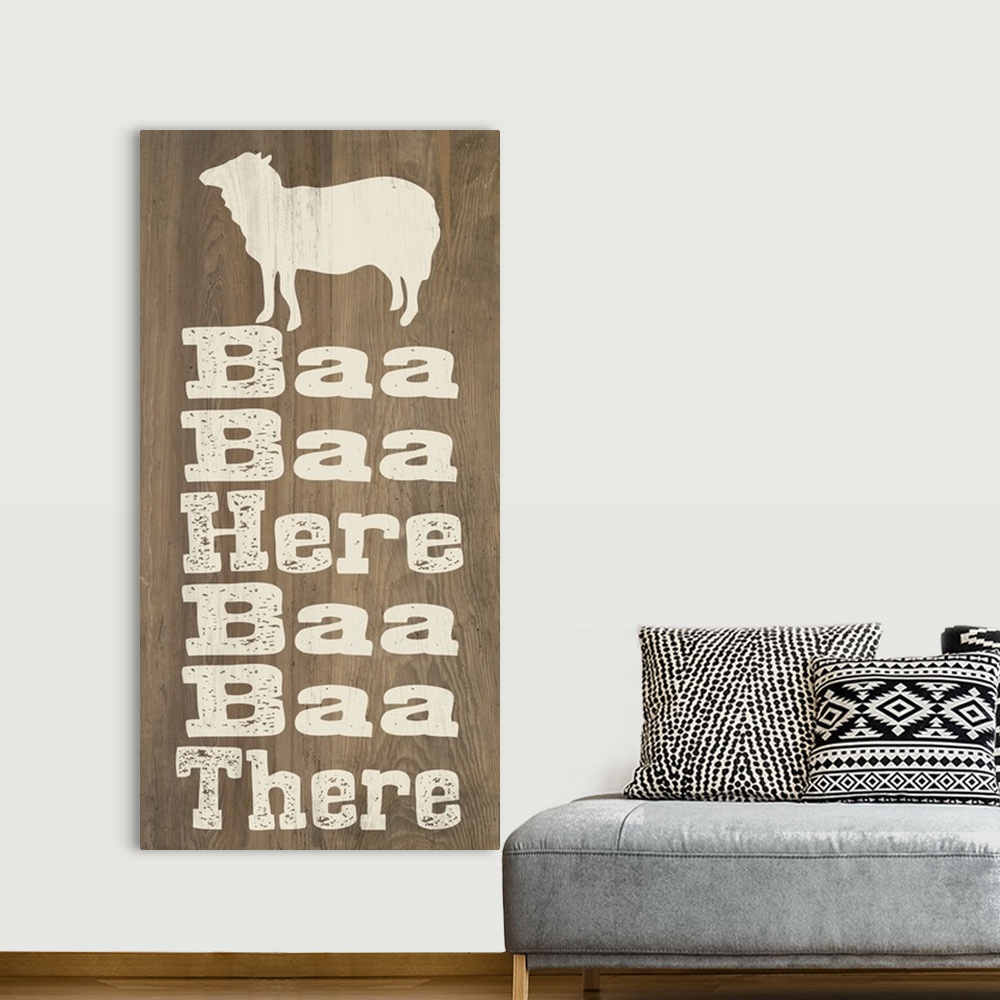 A bohemian room featuring "Baa Baa Here Baa Baa There" written on a wooden background with a sheep silhouette at the top.