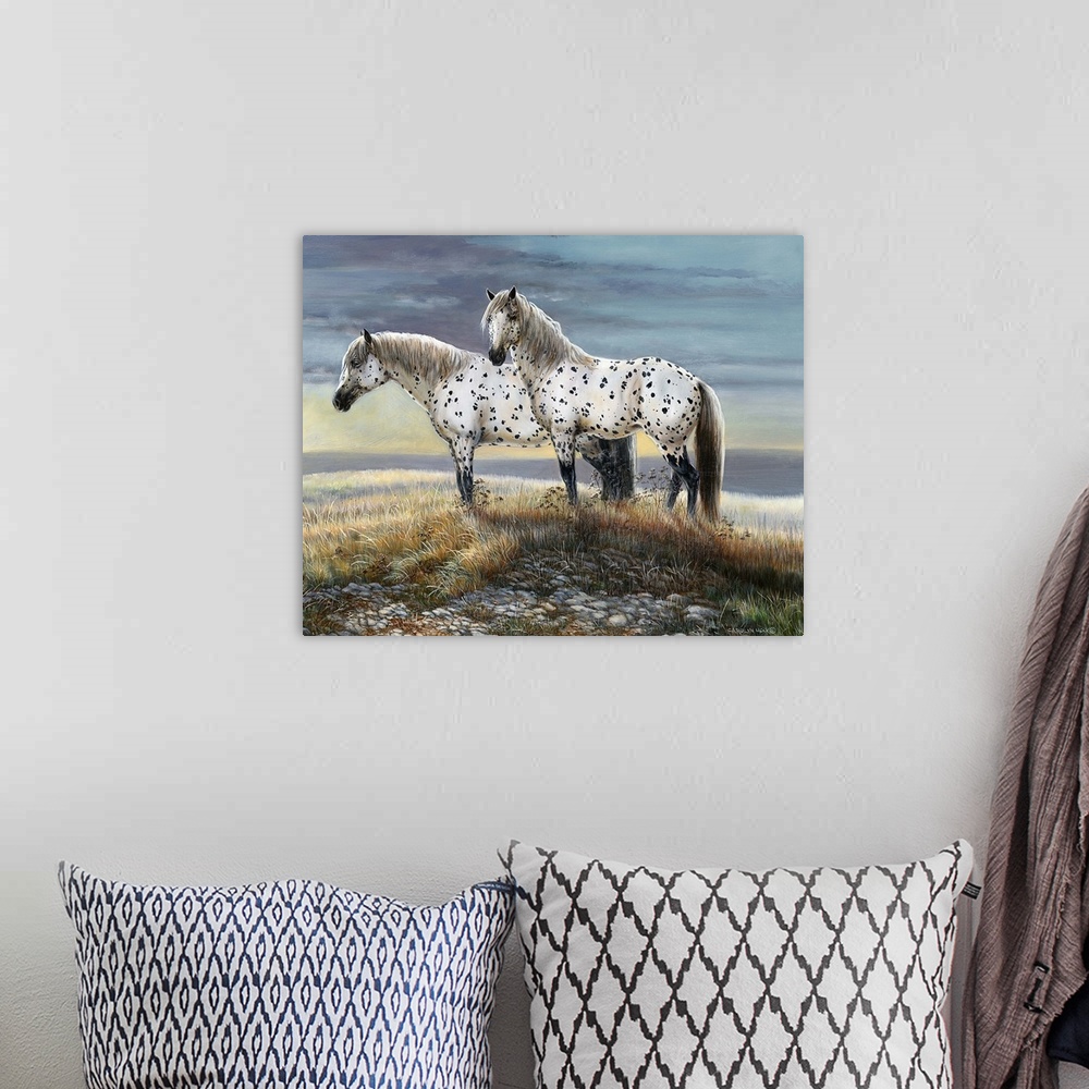 A bohemian room featuring Contemporary painting of two spotted horses standing on a countryside hill.