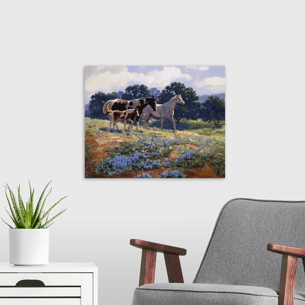 A modern room featuring Contemporary colorful painting of a herd of horses in a countryside clearing.