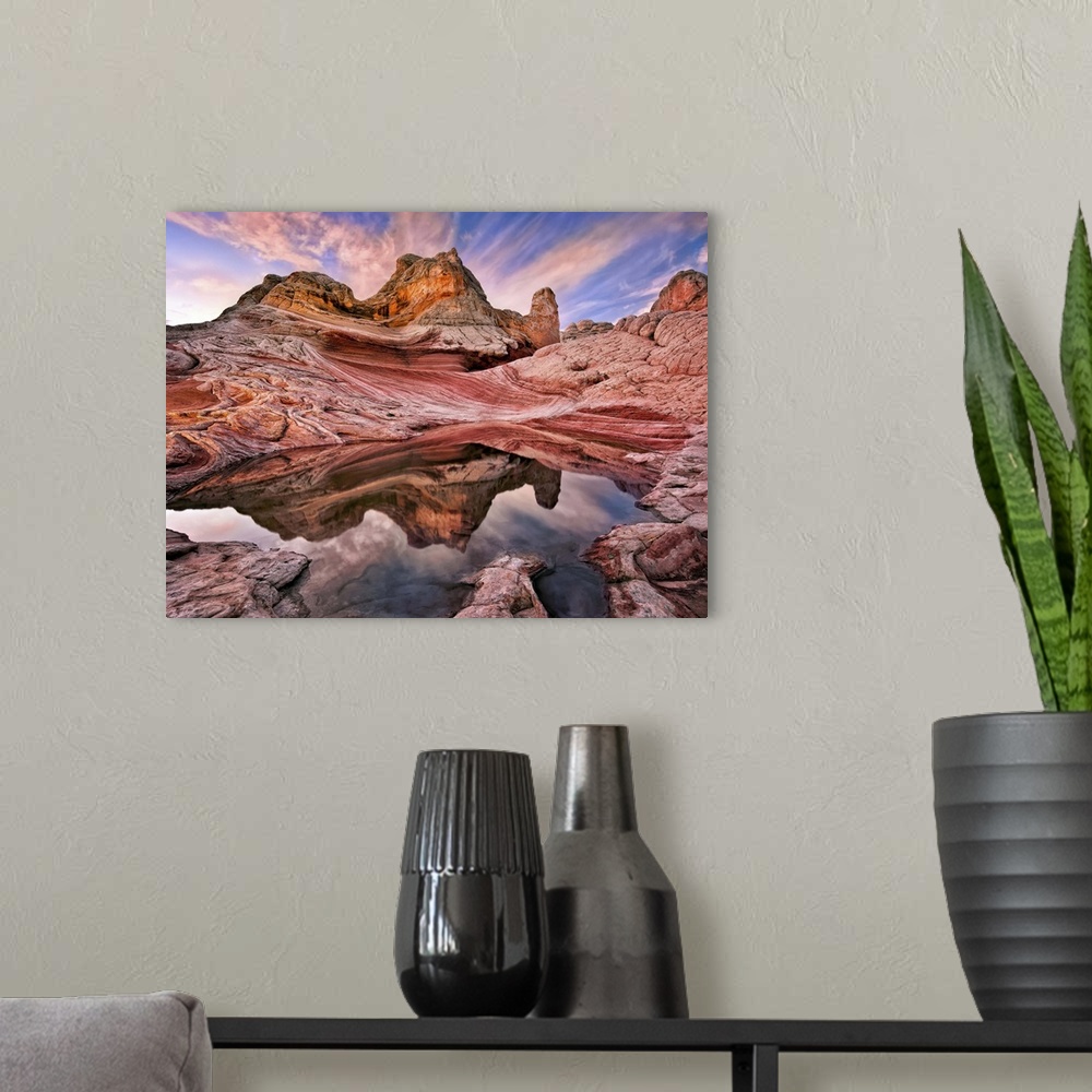 A modern room featuring Rock formations in the Arizona desert under a sky in pink and blue sunset light.