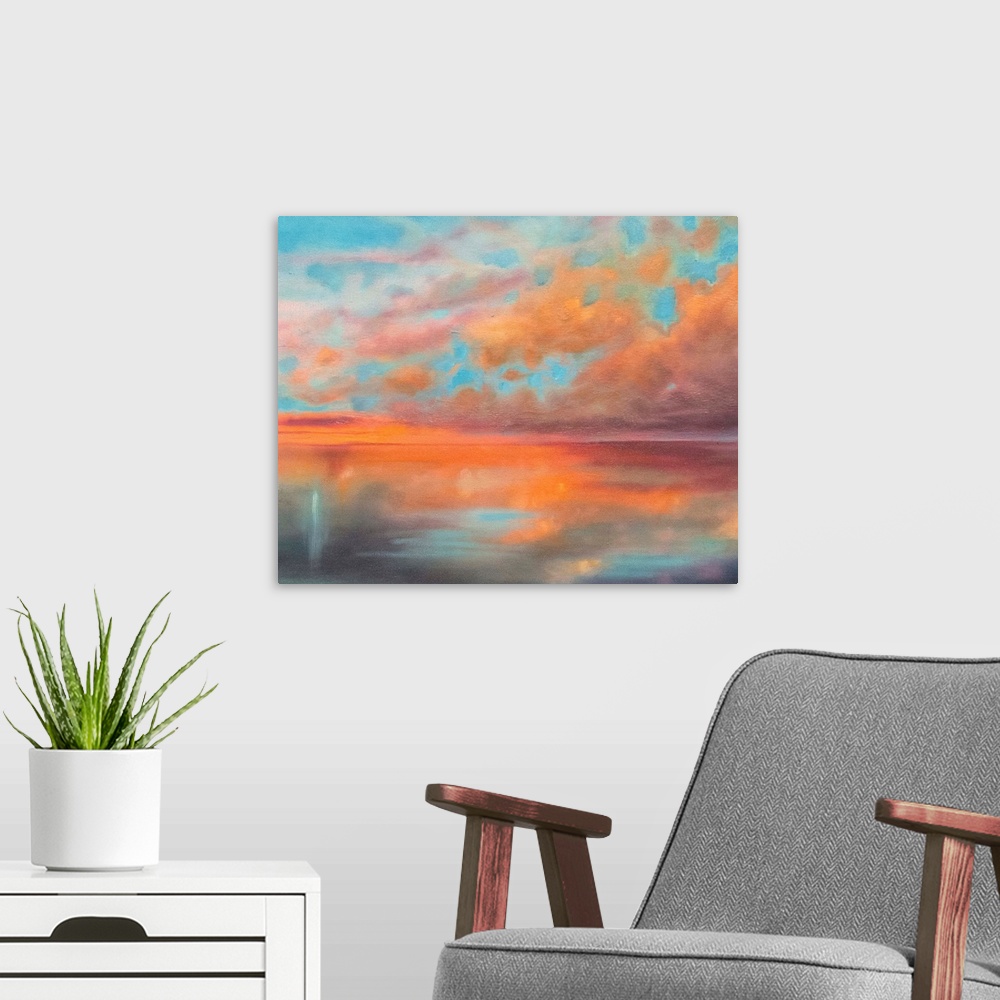 A modern room featuring Contemporary artwork of a stunning sunset with orange clouds against a turquoise sky over the ocean.