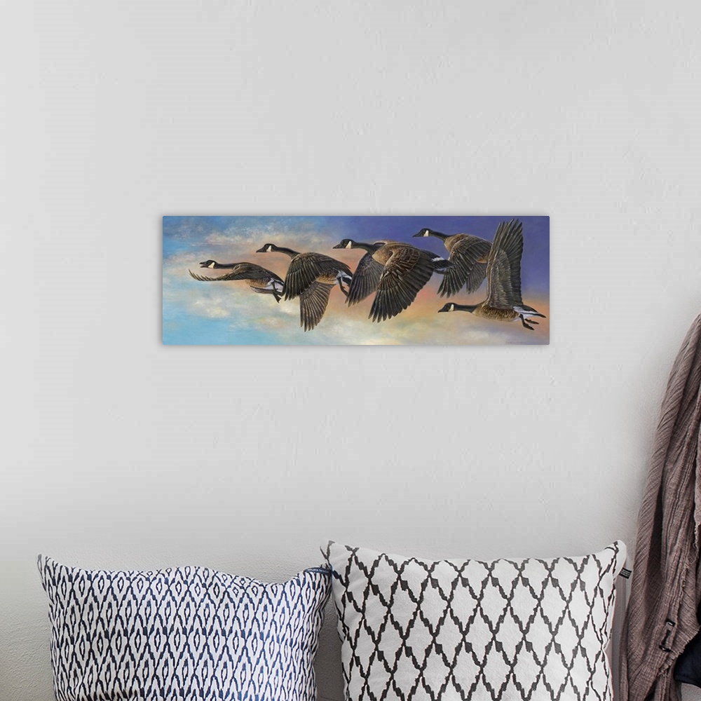 A bohemian room featuring Contemporary painting of geese in mid flight.