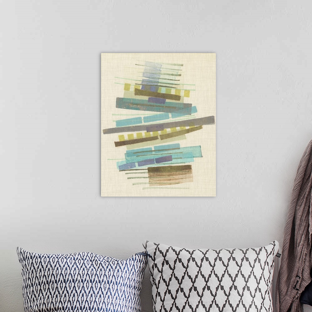 A bohemian room featuring Mid-century inspired abstract artwork using muted colors in stacked rectangular shapes.