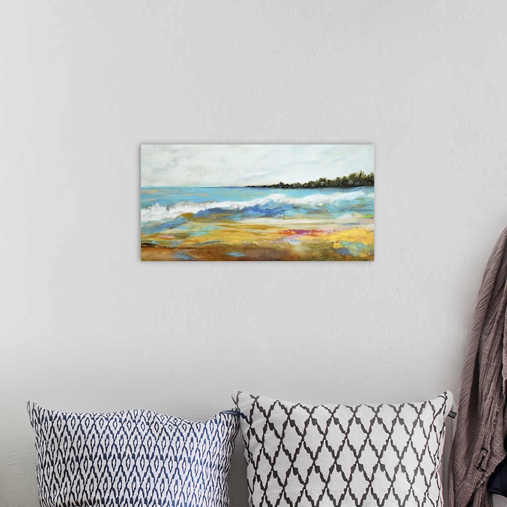 A bohemian room featuring Contemporary artwork of waves of ocean water on a sandy beach.