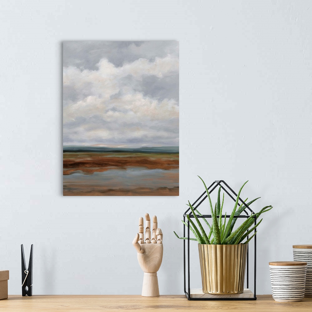 A bohemian room featuring Contemporary landscape painting with a sky filled with clouds.