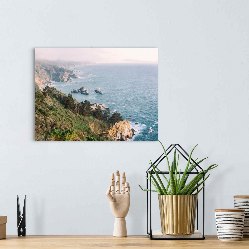 A bohemian room featuring A high angled photograph of the rocky cliffs of Big Sur, California.