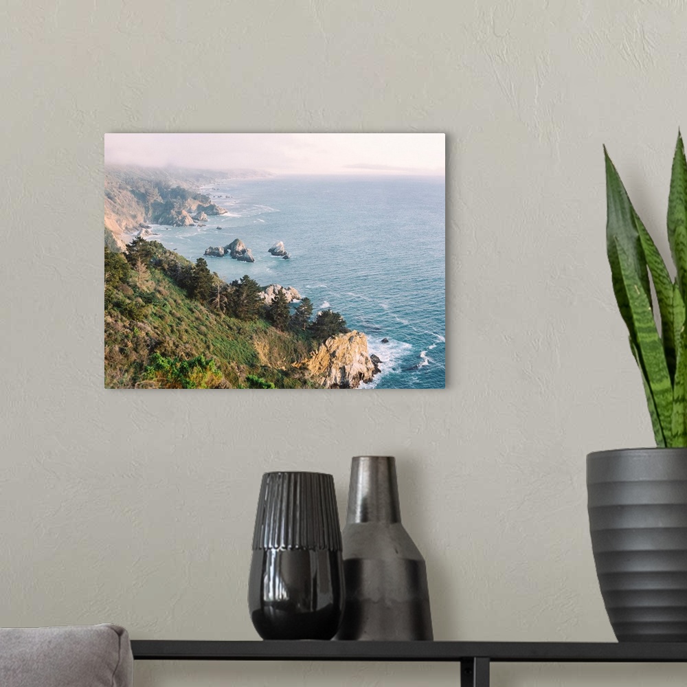 A modern room featuring A high angled photograph of the rocky cliffs of Big Sur, California.