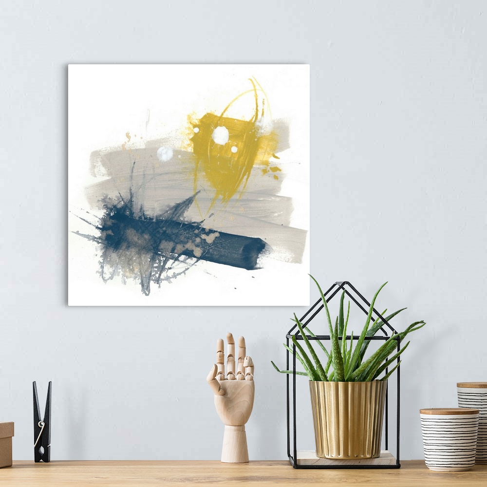 A bohemian room featuring Abstract art on a square canvas with yellow, grey, and navy blue paint splatters.