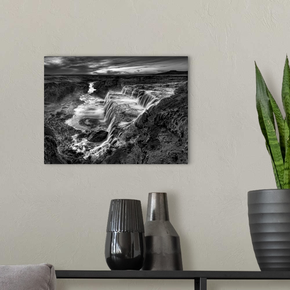 A modern room featuring Striking black and white photograph of waterfalls in the desert.