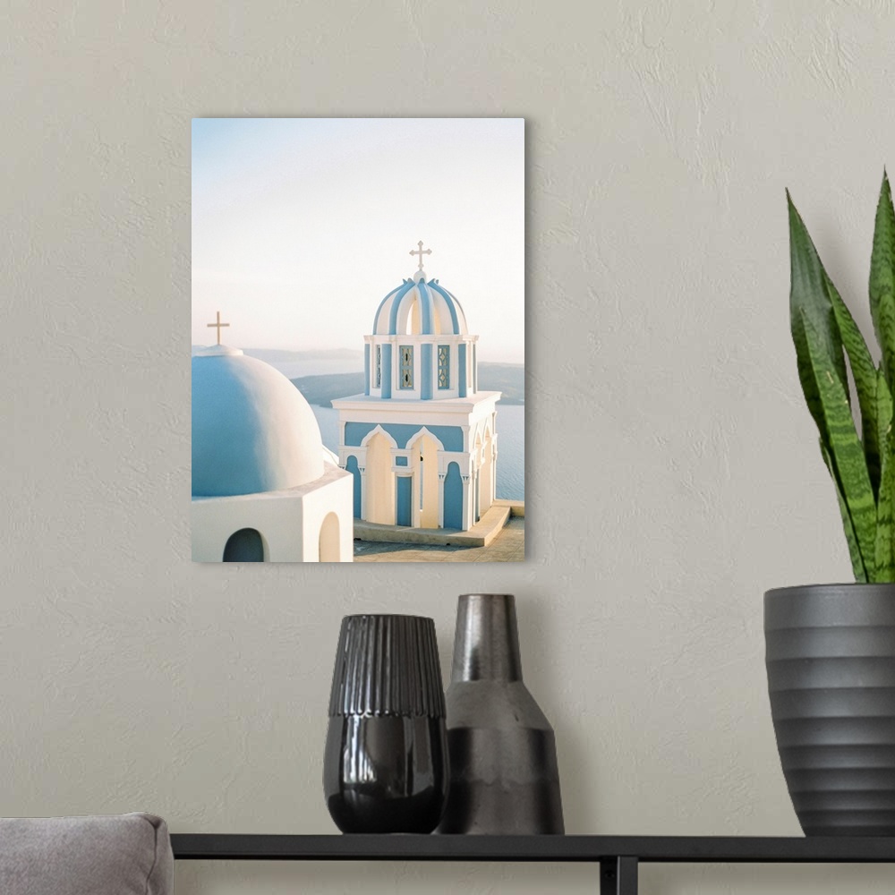 A modern room featuring Photograph of simple church buildings with blue domed roofs, Santorini, Greece.