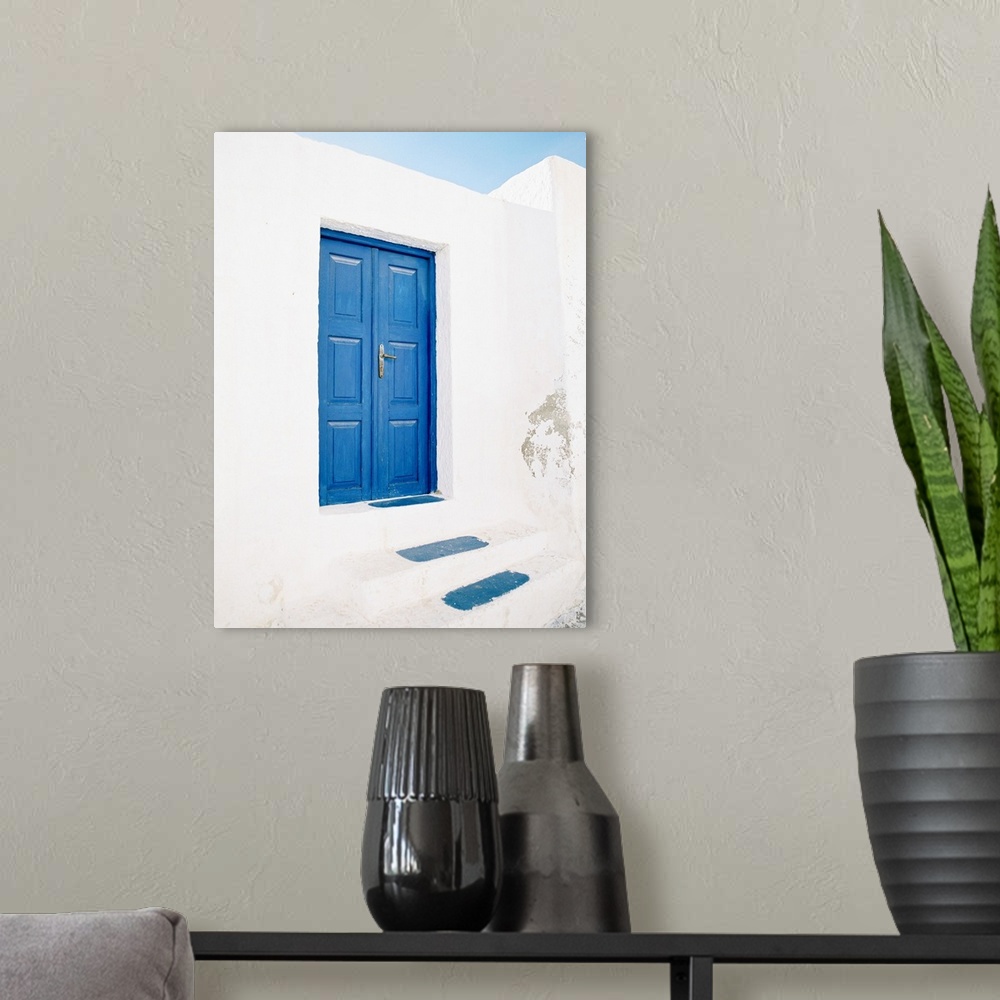 A modern room featuring Photograph of a pair of doors and steps painted in the iconic shade of blue that Santorini, Greec...
