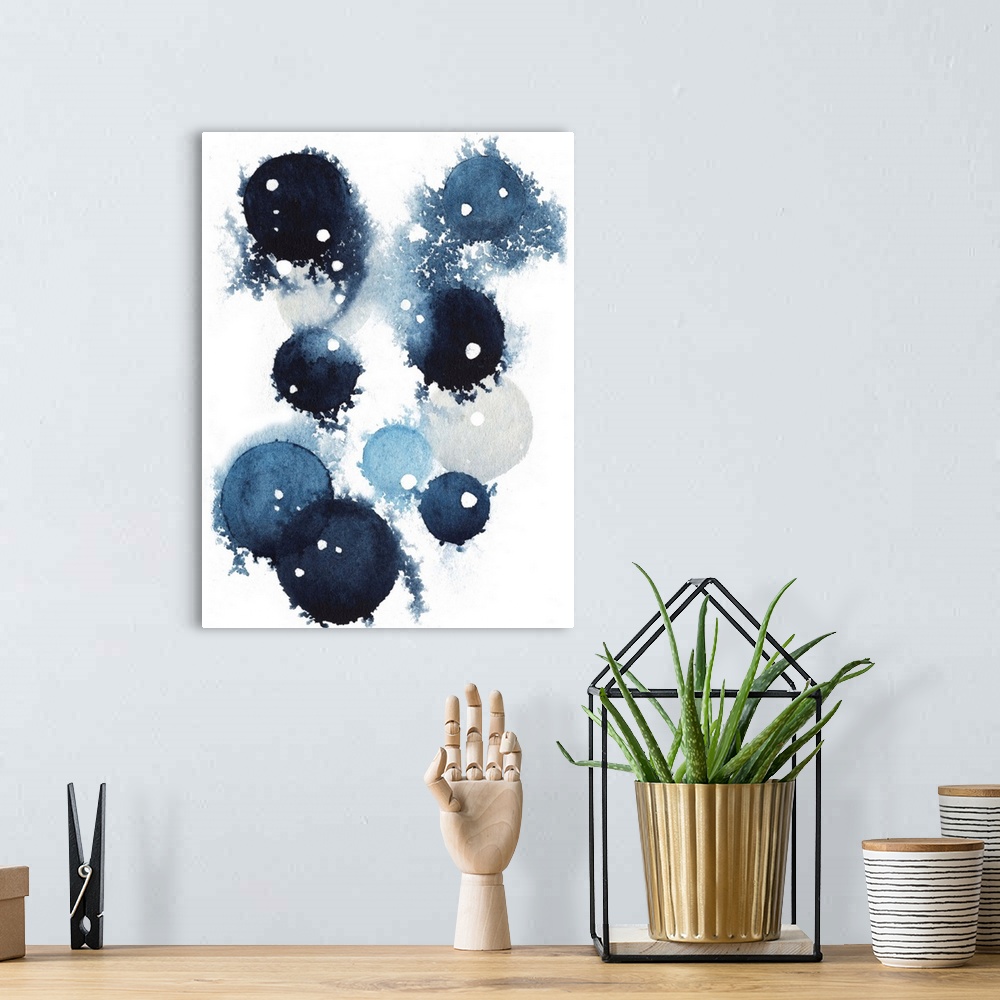 A bohemian room featuring Contemporary abstract artwork of blue globular shapes with bleed stretching out into empty space.