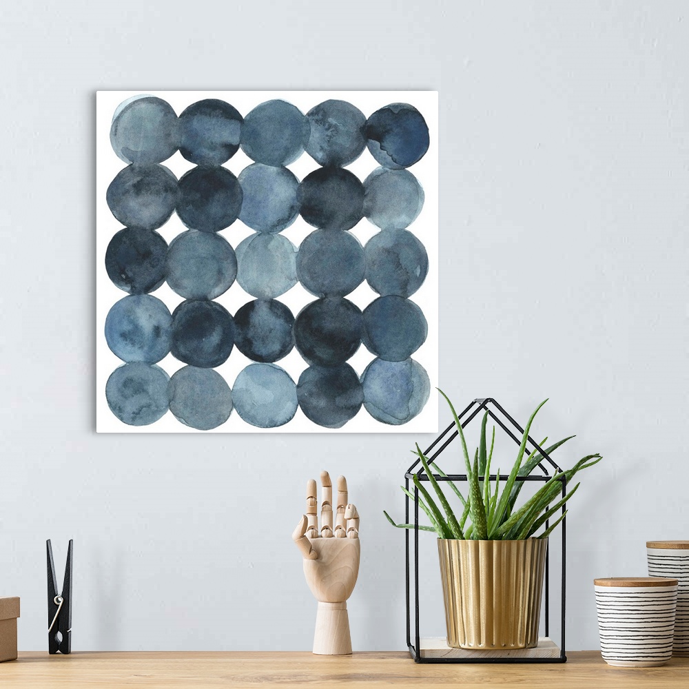 A bohemian room featuring Dot-patterned abstract watercolor painting of blue-gray tones.
