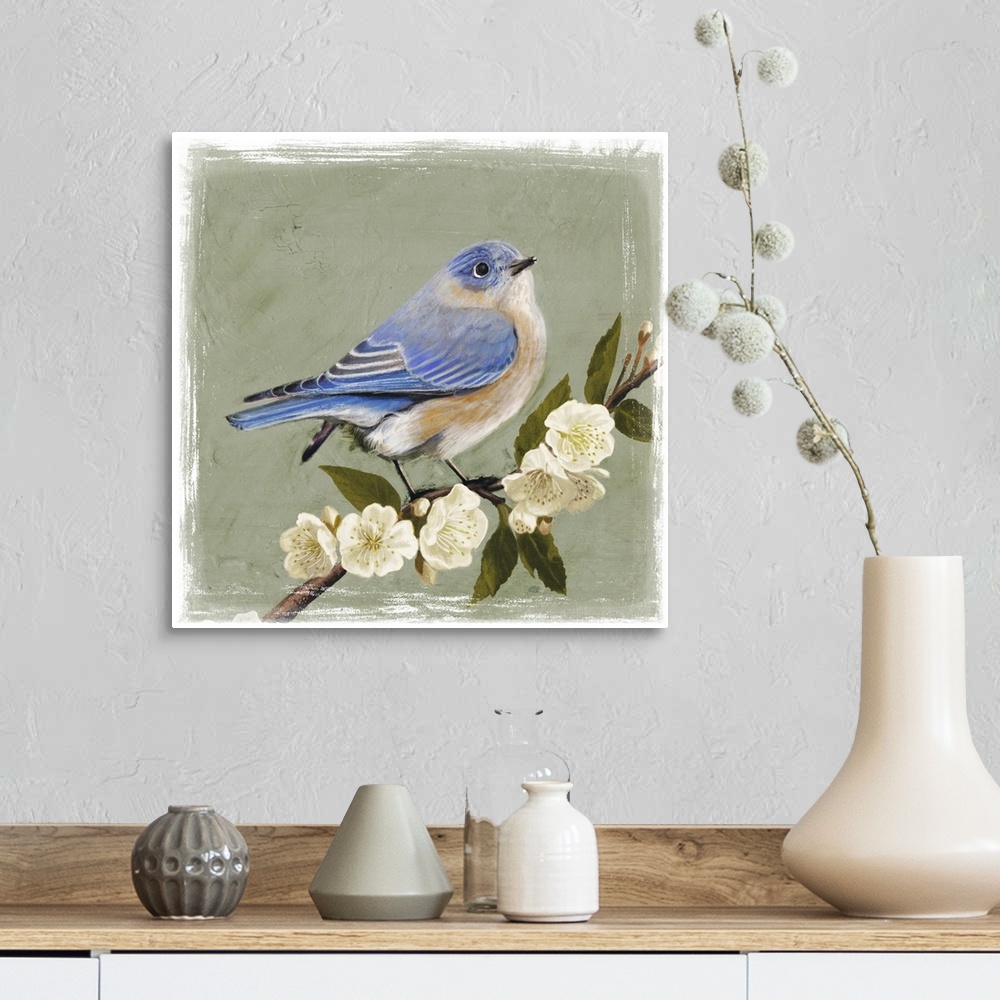 A farmhouse room featuring Decorative artwork of a bluebird is perched on a cherry blossom branch on a muted green background.