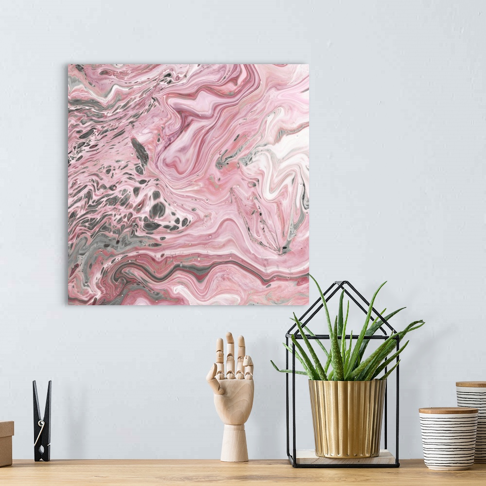 A bohemian room featuring Square abstract decor with marbling colors of pink, gray, and white.