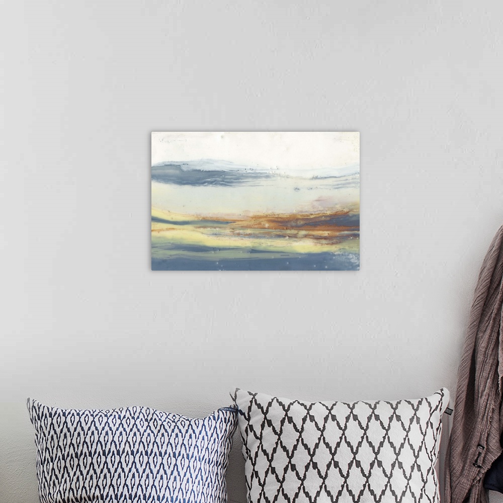 A bohemian room featuring Watercolor abstract artwork in soft, blurred layers of orange and blue.