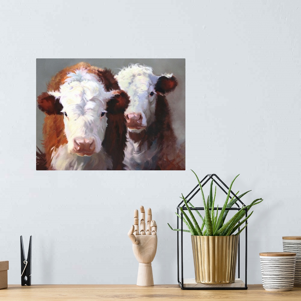 A bohemian room featuring Contemporary painting of two brown and white cows standing closely together.