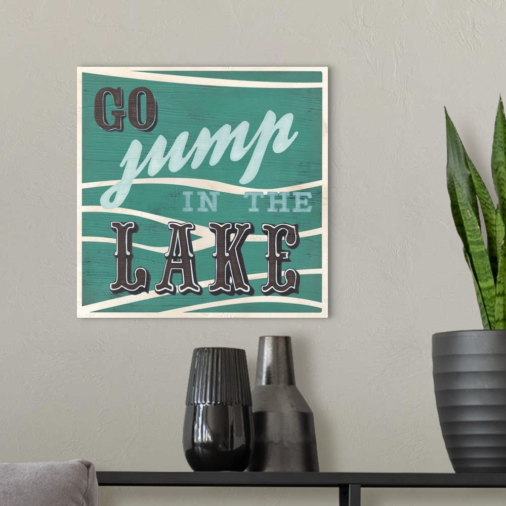 A modern room featuring Decorative sign for a cabin or lodge that reads "Go Jump In The Lake."