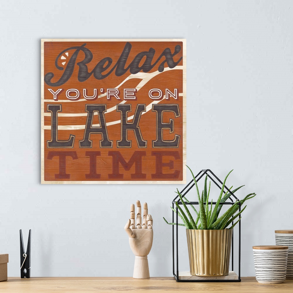 A bohemian room featuring Decorative sign for a cabin or lodge that reads "Relax, You're On Lake Time."