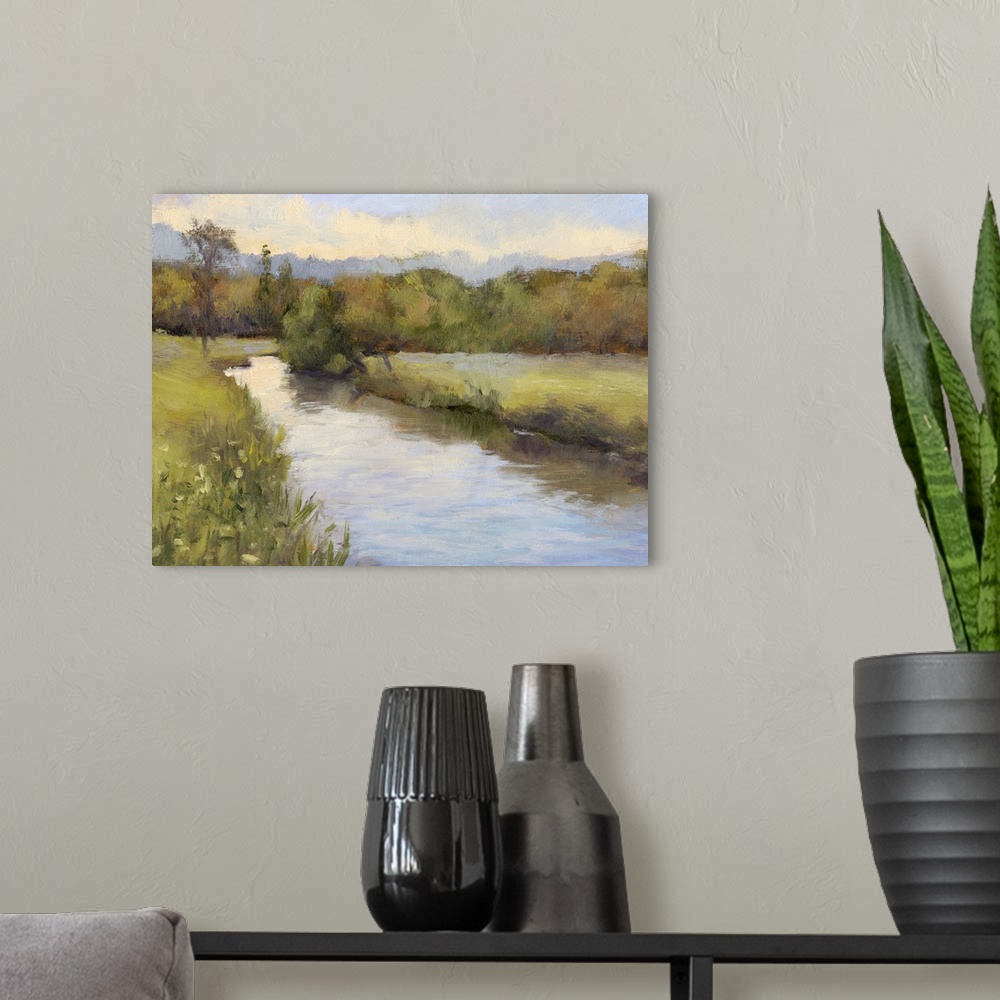 A modern room featuring Contemporary painting of a river cutting through a green countryside.