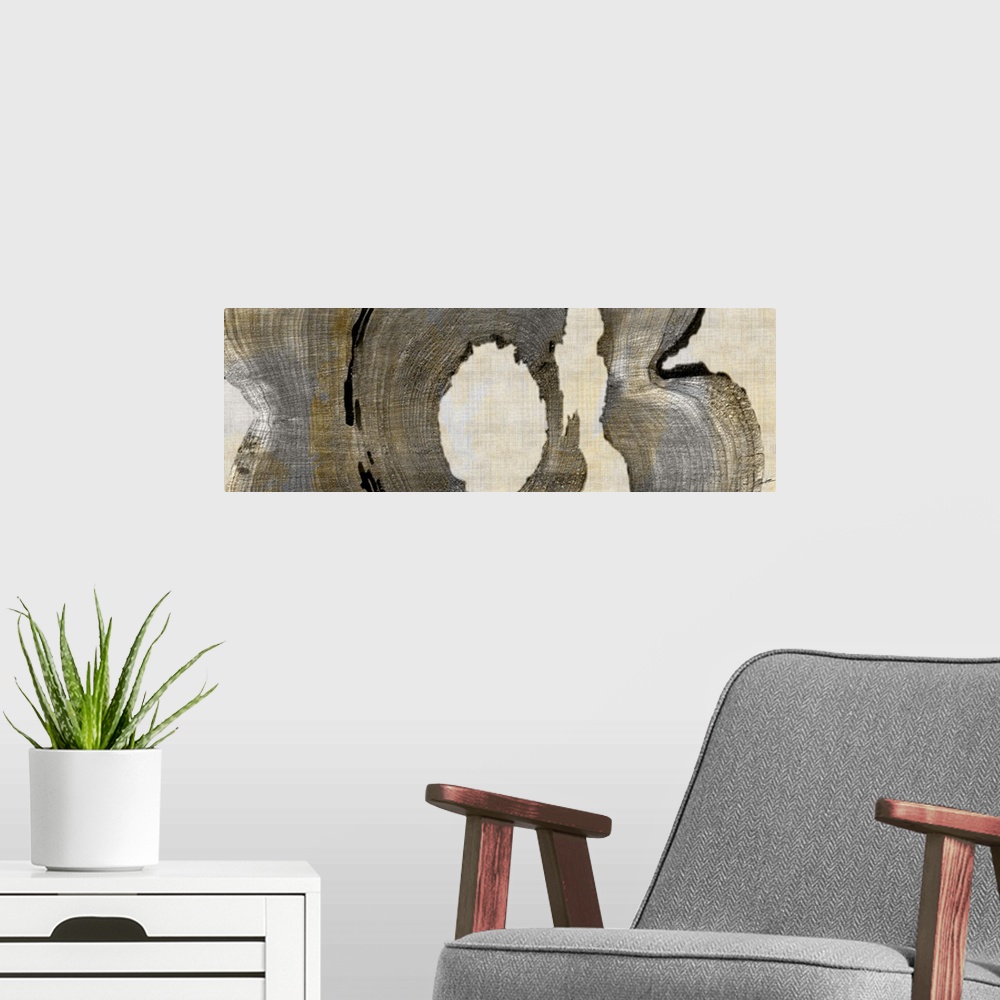 A modern room featuring Abstract artwork in brown shades made from cross sections of tree trunks.