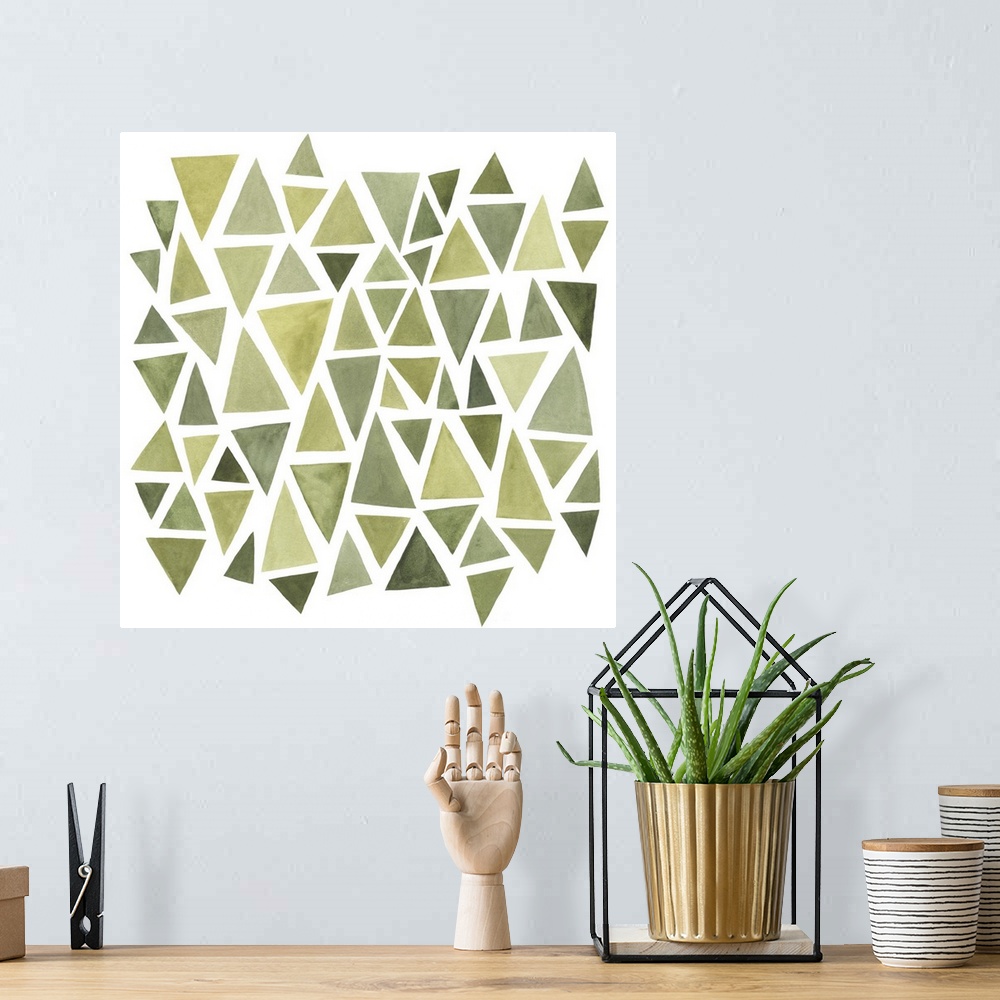 A bohemian room featuring A square decorative image of different sized triangles in varies shades of green on a white backg...