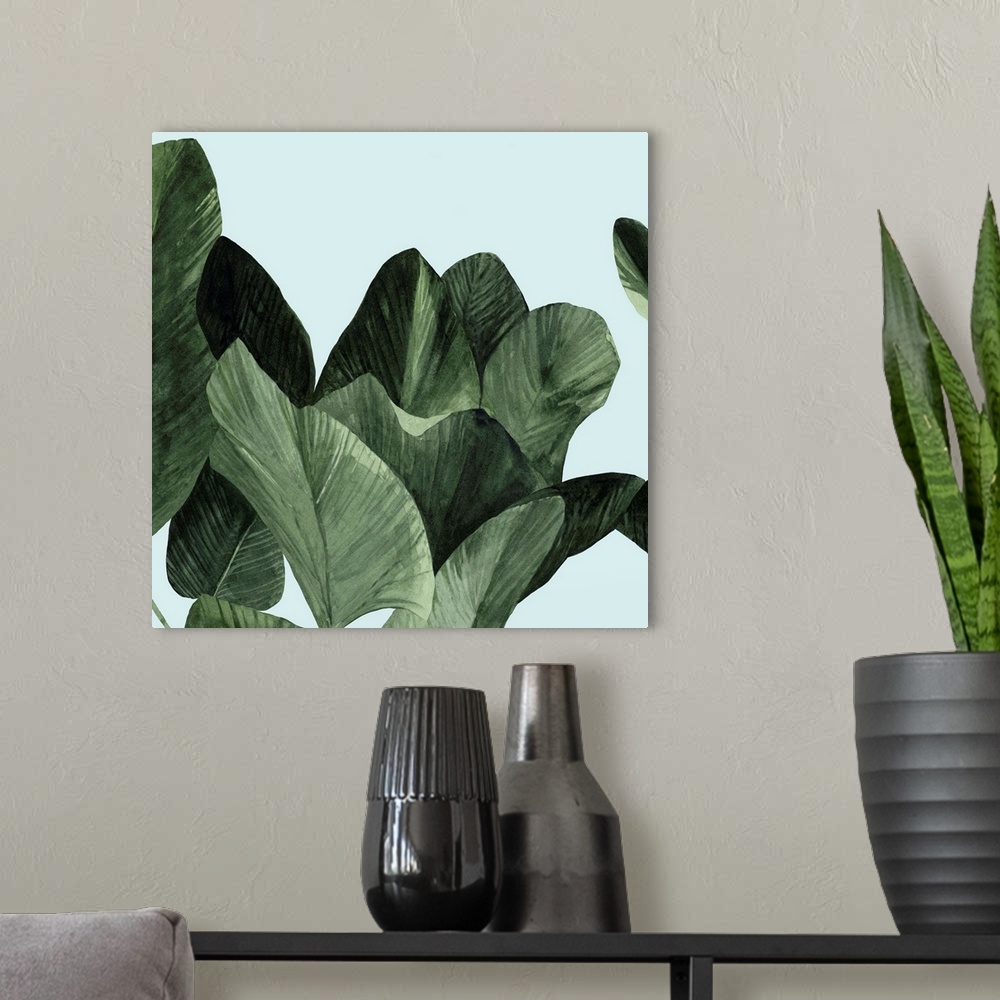 A modern room featuring Square modern painting of large palm leaves over a light blue backdrop.