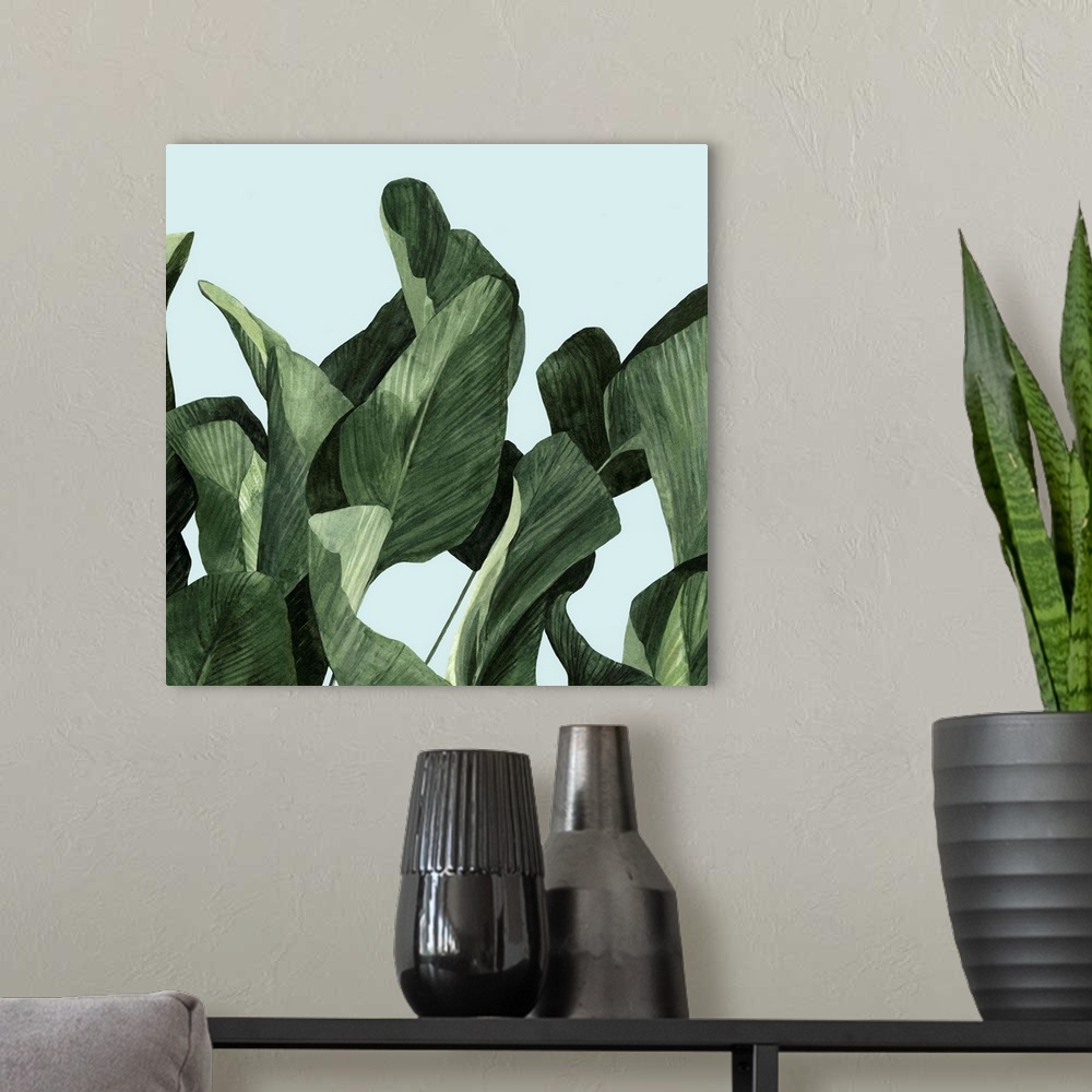 A modern room featuring Square modern painting of large palm leaves over a light blue backdrop.