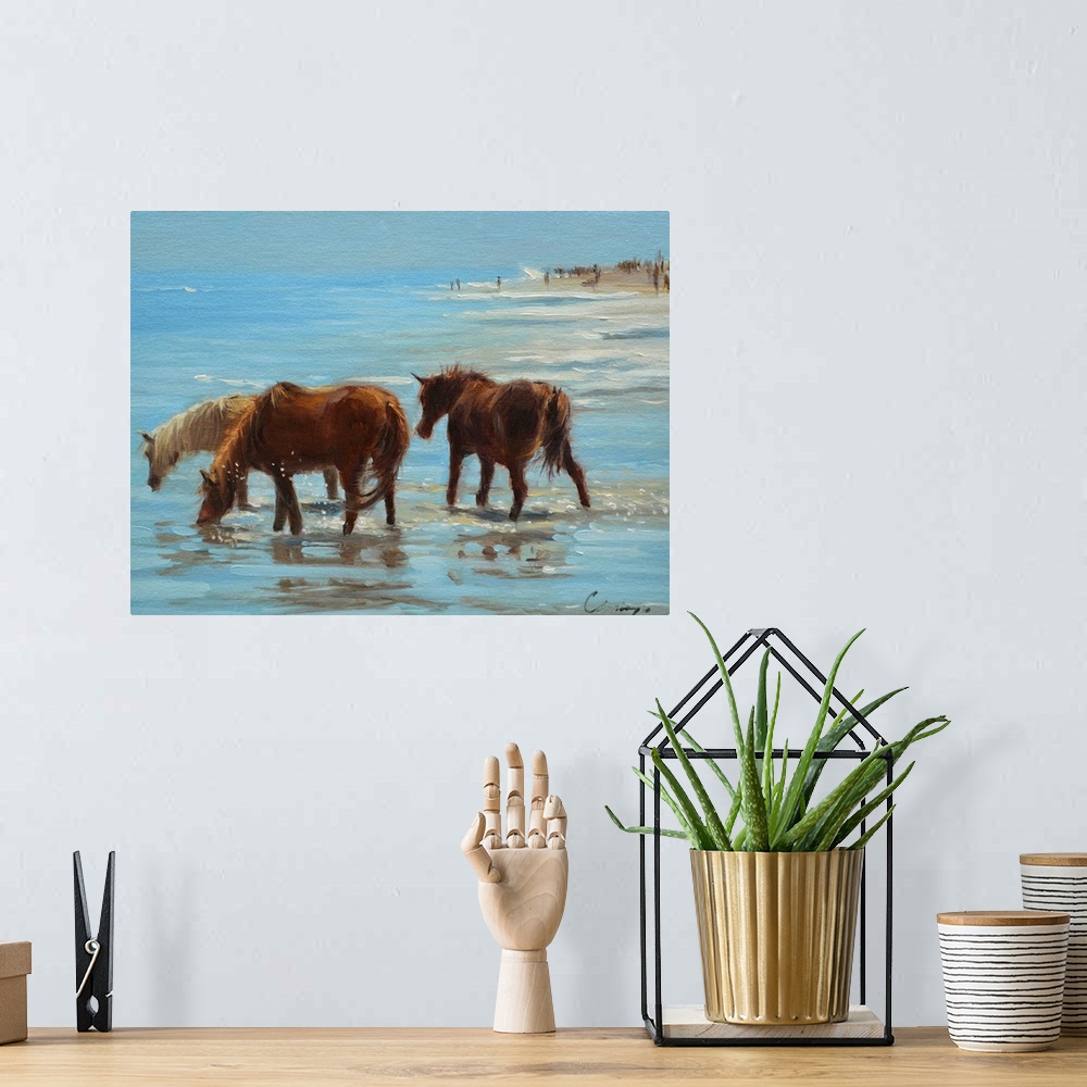 A bohemian room featuring A painting of horses on a beach wading through shallow water.