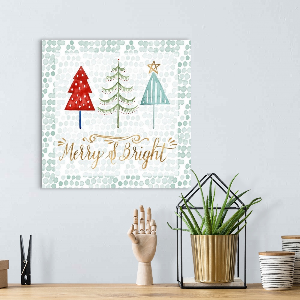 A bohemian room featuring A trio of three colorful patterned Christmas trees with gold script.