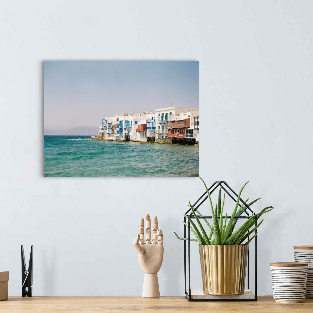 A bohemian room featuring Photograph of white buildings with colorful balconies overlooking the water in Mykonos, Greece.