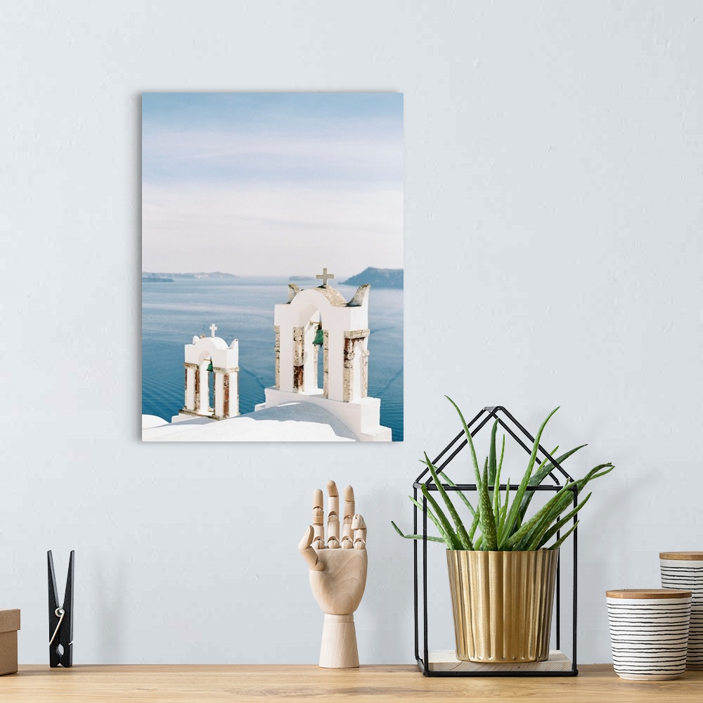 A bohemian room featuring Photograph of church bell towers overlooking the ocean in the Greek city of Oia, Santorini.